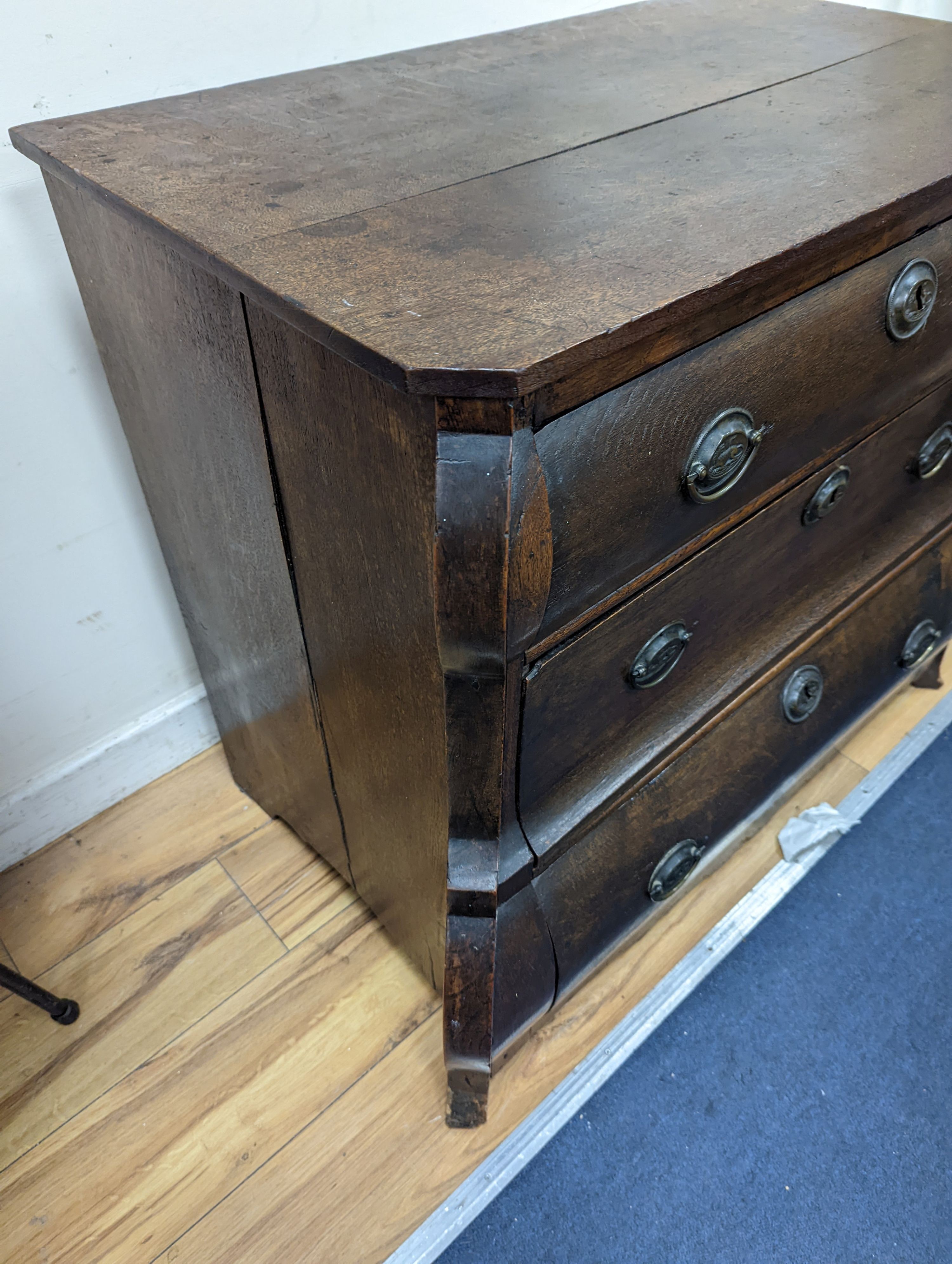 An 18th century Dutch oak three drawer bombe chest, width 94cm, depth 50cm, height 76cm